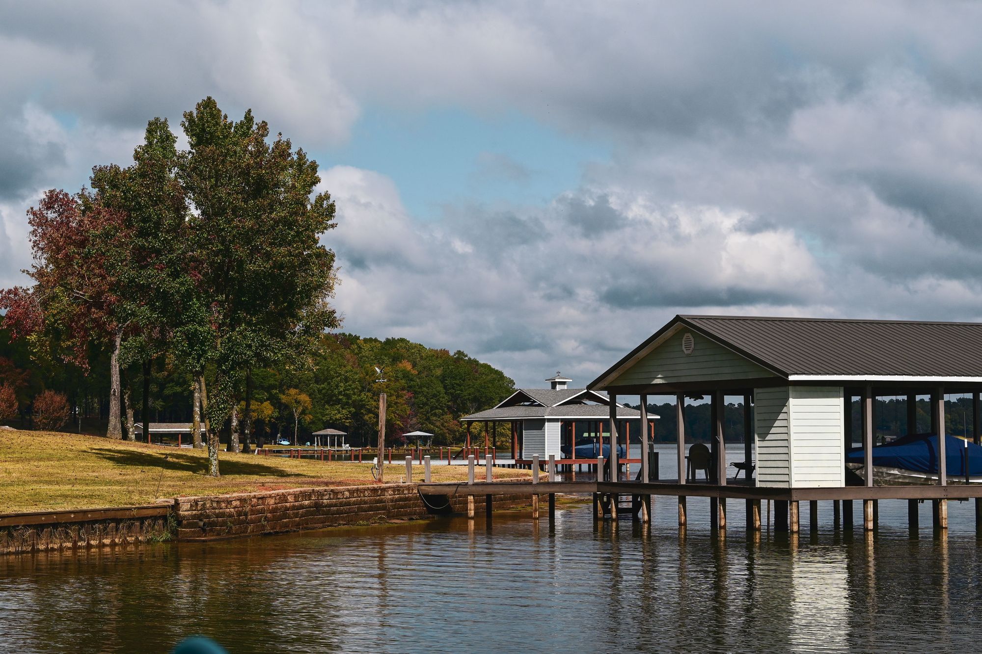 Hero photo. Signature project — wide, warm light, deck or pavilion. Video-ready slot.