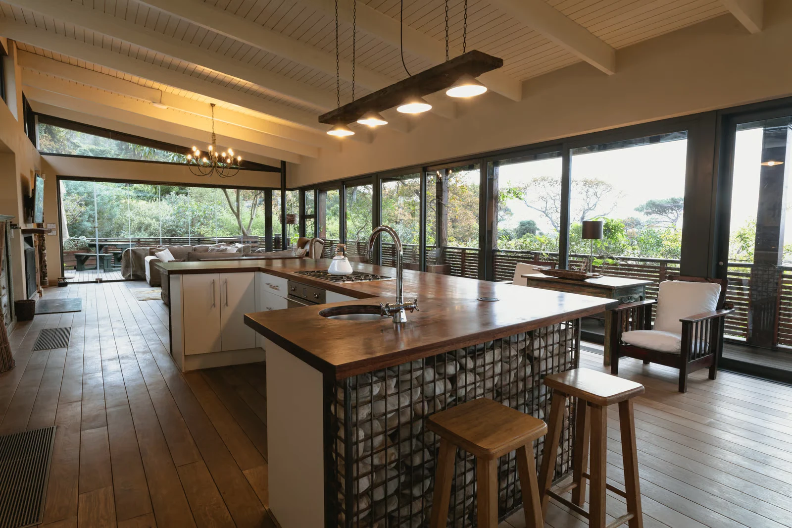 Photo. Open-plan interior under exposed beams, wide glazing