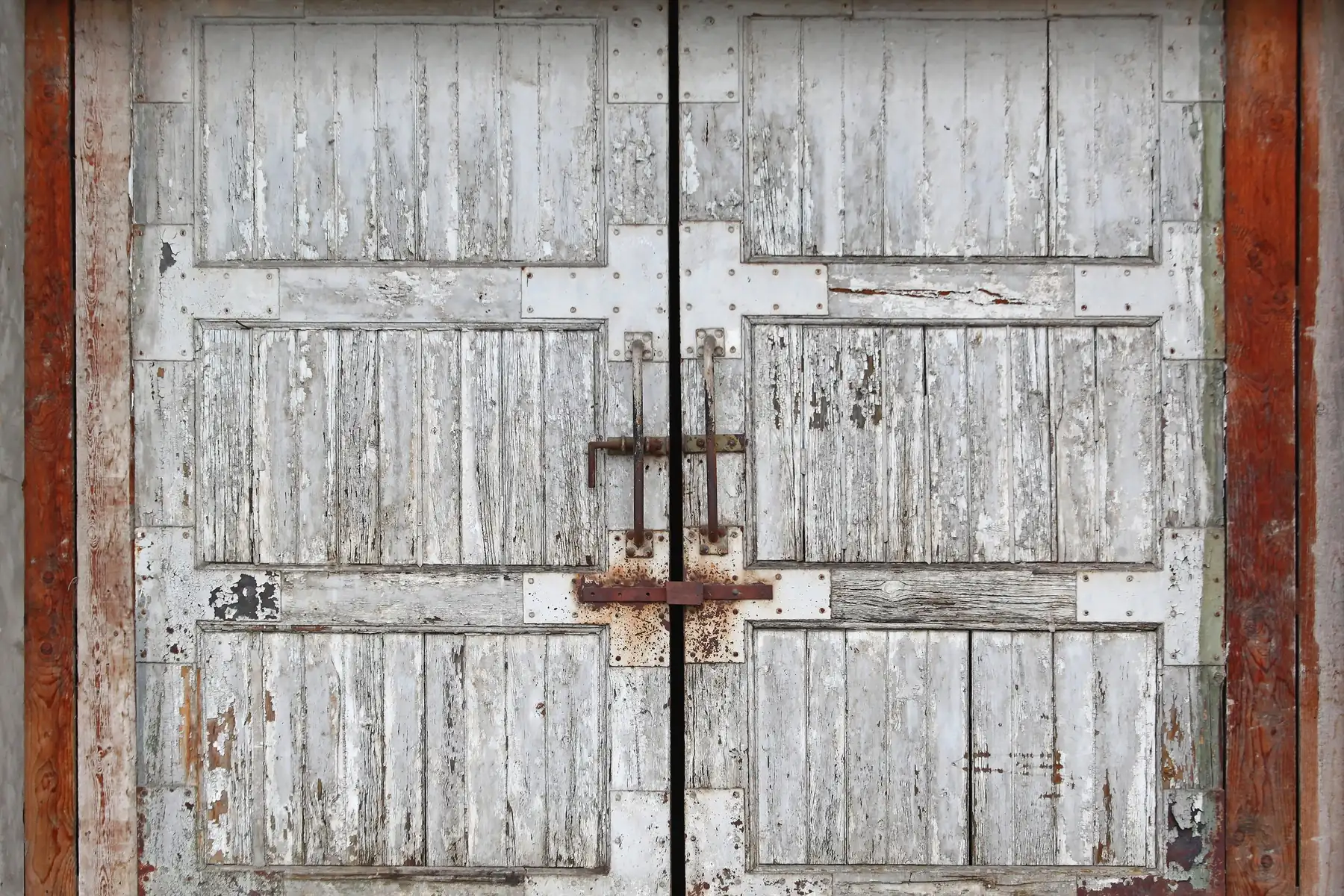 Photo. Reclaimed barn doors, weathered paint and forged hardware